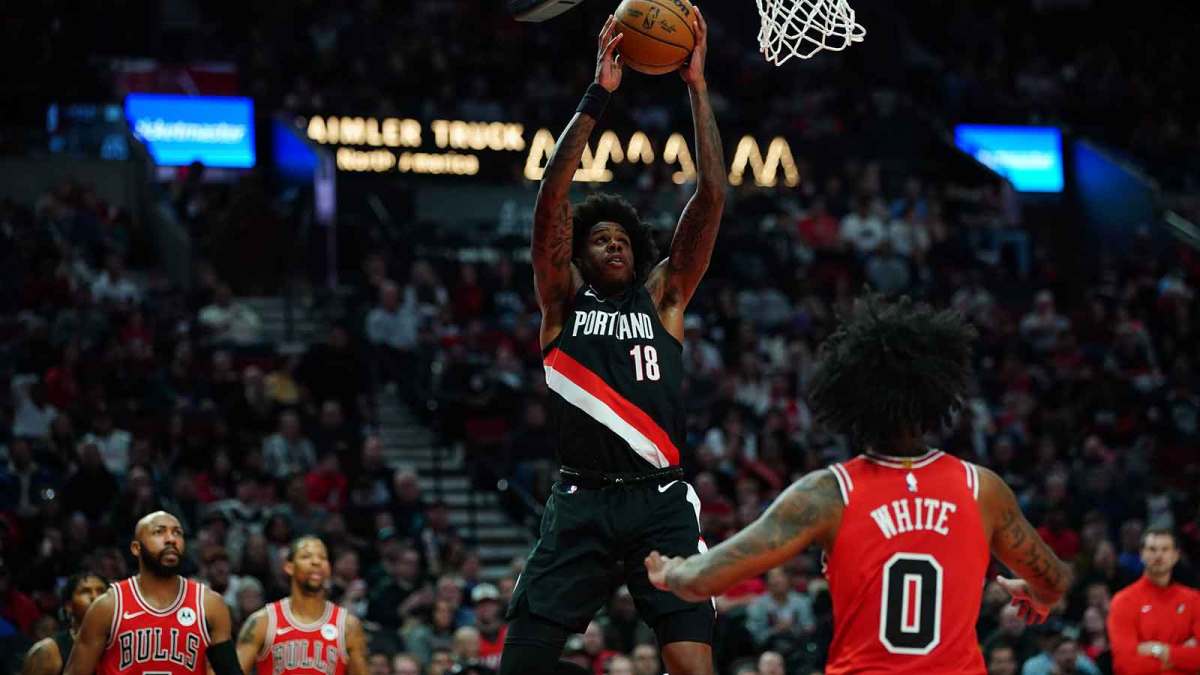 Portland Trail Blazers guard Javonte Cooke (18) goes up for a dunk as Chicago Bulls guard Coby White (0) looks on during the first half at Moda Center.