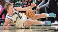Milwaukee Bucks guard AJ Green (20) falls after a foul in the third quarter against the Brooklyn Nets at Fiserv Forum.