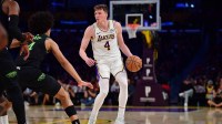 Los Angeles Lakers forward Dalton Knecht (4) controls the ball against the New Orleans Pelicans during the first half at Crypto.com Arena.