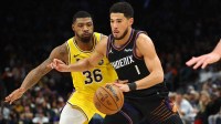 Phoenix Suns guard Devin Booker (1) against Los Angeles Lakers guard Marcus Smart (36) in the first half at Mortgage Matchup Center.
