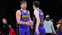 Los Angeles Lakers guard Luka Doncic (77) and guard Austin Reaves (15) react against the San Antonio Spurs in the first half at Crypto.com Arena.