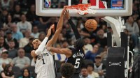 San Antonio Spurs forward Victor Wembanyama (1) dunks over Utah Jazz forward Cody Williams (5) during the first half at Frost Bank Center.