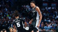 San Antonio Spurs forward Victor Wembanyama (1) celebrates with San Antonio Spurs guard Stephon Castle (5) during the first half against the Dallas Mavericks at American Airlines Center.