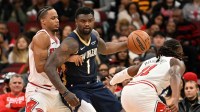 New Orleans Pelicans forward Zion Williamson (1) controls the ball against Chicago Bulls forward Isaac Okoro (35) and guard Ayo Dosunmu (11) during the first half at United Center.