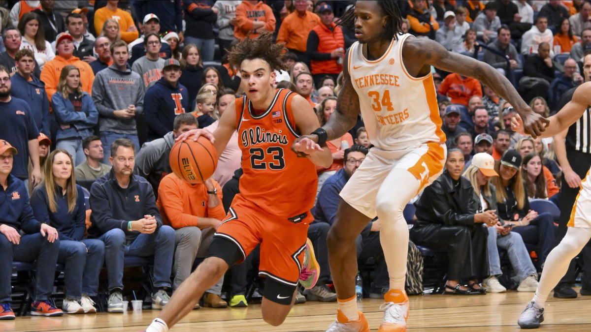 Illinois Fighting Illini guard Keaton Wagler (23) drives to the baseline past Tennessee Volunteers center Felix Okpara (34) during the second half at Bridgestone Arena.