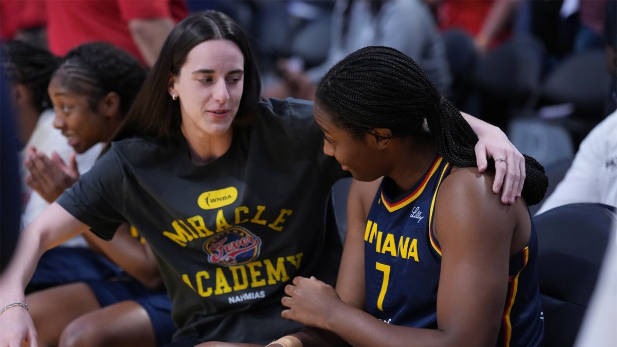 Indiana Fever guard Caitlin Clark (22) gives a hug to forward Aliyah Boston (7) in the first half against the LA Sparks at Crypto.com Arena.
