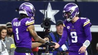 Minnesota Vikings wide receiver Jalen Nailor (1) celebrates with quarterback J.J. McCarthy (9) after a touchdown catch during the second half against the Dallas Cowboys at AT&T Stadium.