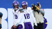 Minnesota Vikings quarterback J.J. McCarthy (9) reacts with wide receiver Justin Jefferson (18) after rushing for a touchdown against the New York Giants during the first half at MetLife Stadium.