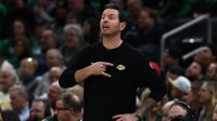 Los Angeles Lakers head coach JJ Redick signals to his players during the first half against the Boston Celtics at TD Garden