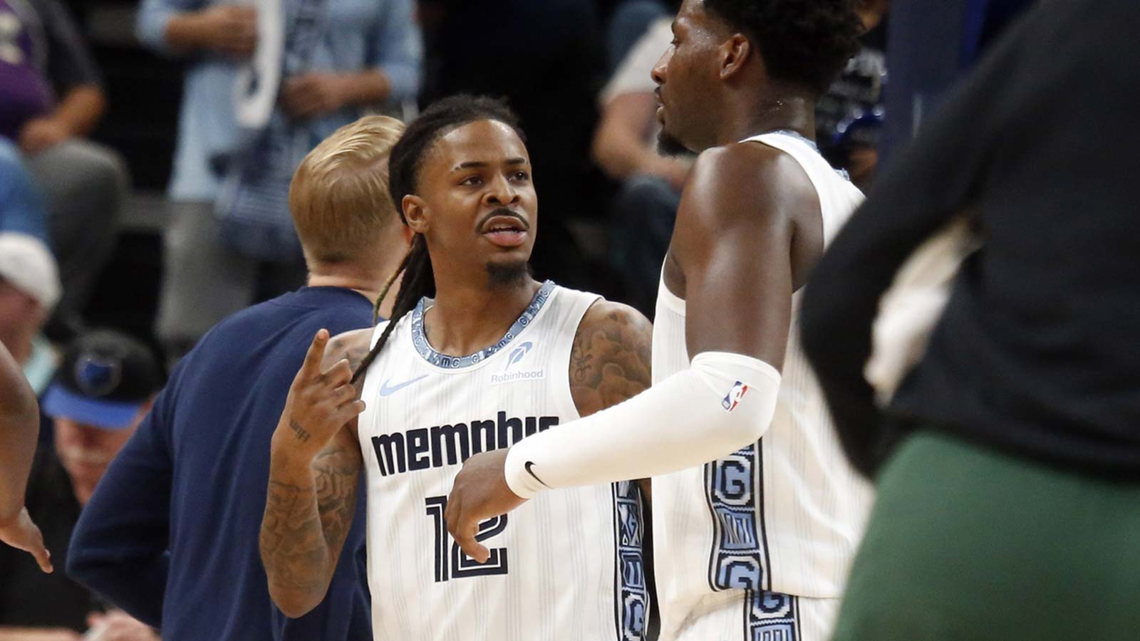 Memphis Grizzlies guard Ja Morant (12) talks with Memphis Grizzlies forward/center Jaren Jackson Jr. (8) during a timeout during the second quarter against the Milwaukee Bucks at FedExForum.