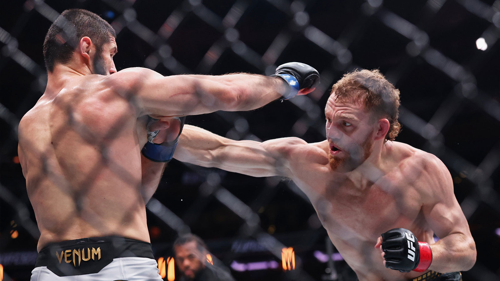Jack Della Maddalena (red gloves) fights Islam Makhachev (blue gloves) in the welterweight championship bout during UFC 322 at Madison Square Garden. 