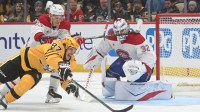 Pittsburgh Penguins center Sidney Crosby stretches for the puck near Montreal Canadiens goalie Jacob Fowler (32) during the first period at PPG Paints Arena.