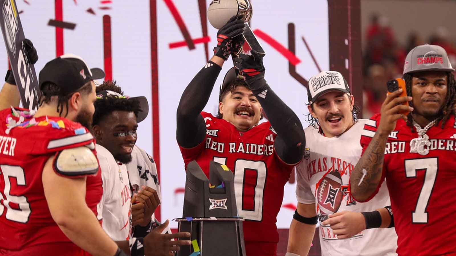 Jacob Rodriguez lifts the trophy after Texas Tech defeated BYU in the Big 12 Conference championship game, Saturday, Nov. 6, 2025, at AT&T Stadium in Arlington.