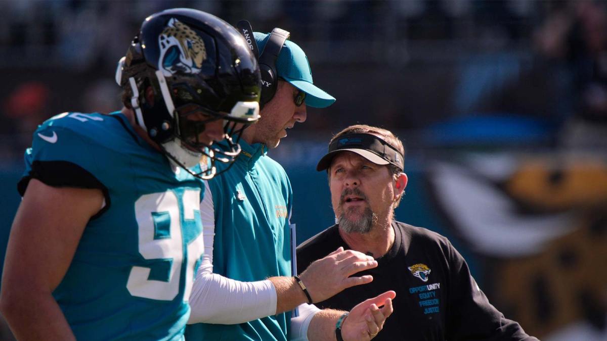 Jacksonville Jaguars head coach Liam Coen talks to one of his staff in the first quarter during an NFL football game at EverBank Stadium.
