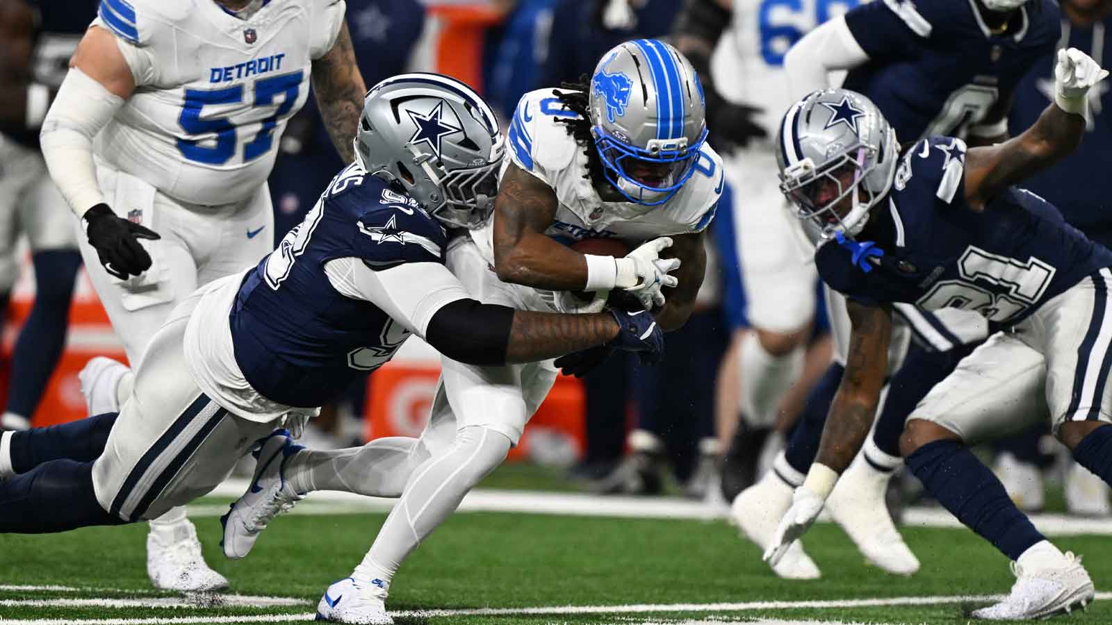 Detroit Lions running back Jahmyr Gibbs (0) is tackled by Dallas Cowboys defensive tackle Quinnen Williams (92) during the first half at Ford Field. 