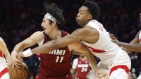 Toronto Raptors forward Scottie Barnes (4) knocks the ball away from Miami Heat forward Jaime Jaquez Jr. (11) during the second half at Kaseya Center.