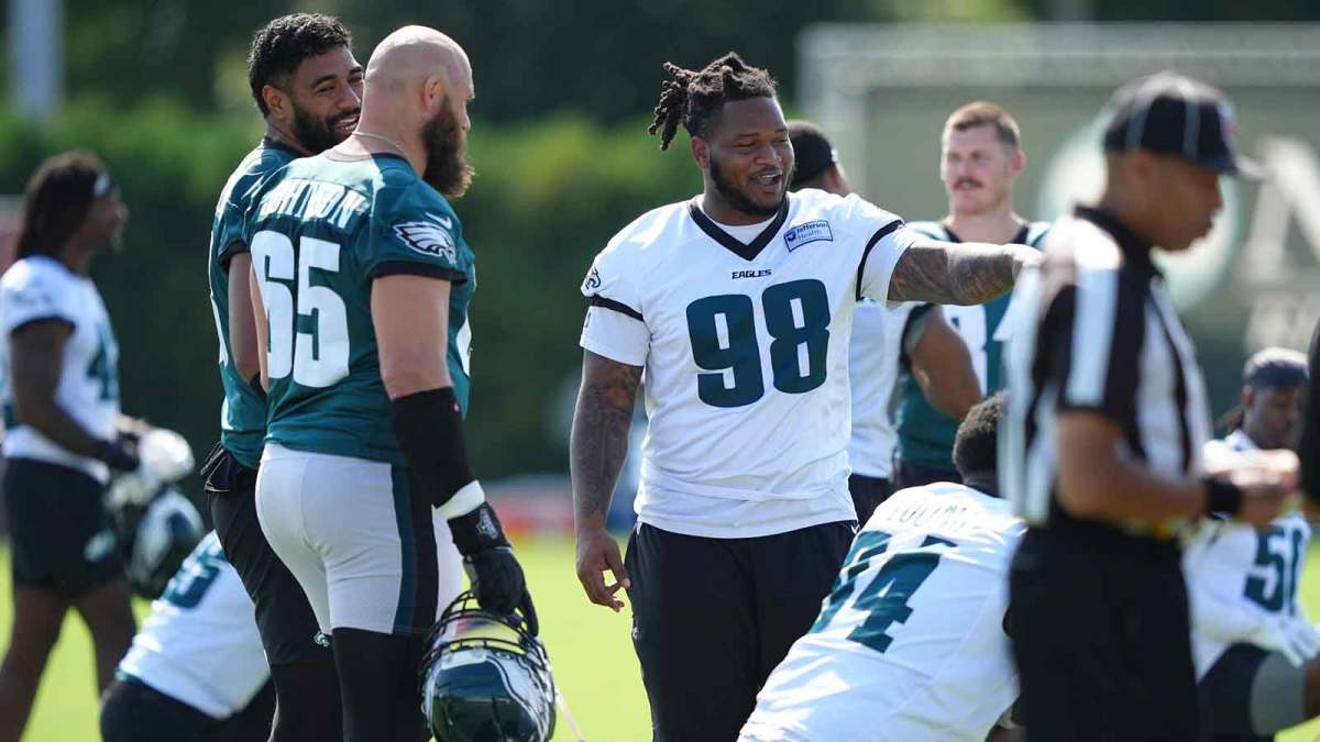 Philadelphia Eagles defensive tackle Jalen Carter (98) reacts with offensive lineman Jordan Mailata (68) and offensive lineman Lane Johnson (65) during training camp at NovaCare Complex.