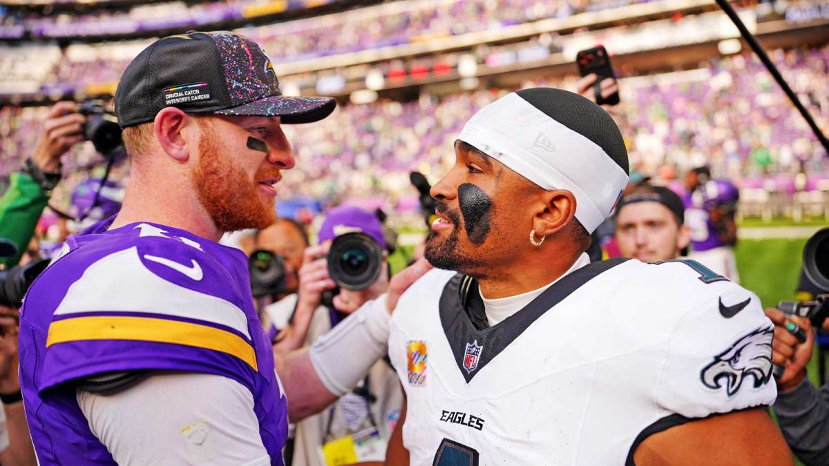 Minnesota Vikings quarterback Carson Wentz (11) and Philadelphia Eagles quarterback Jalen Hurts (1) react after the game at U.S. Bank Stadium.