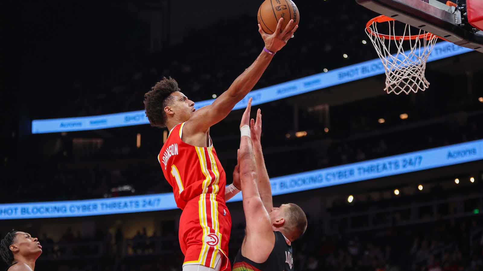 Atlanta Hawks forward Jalen Johnson (1) shoots over Denver Nuggets center Nikola Jokic (15) in the first quarter at State Farm Arena.