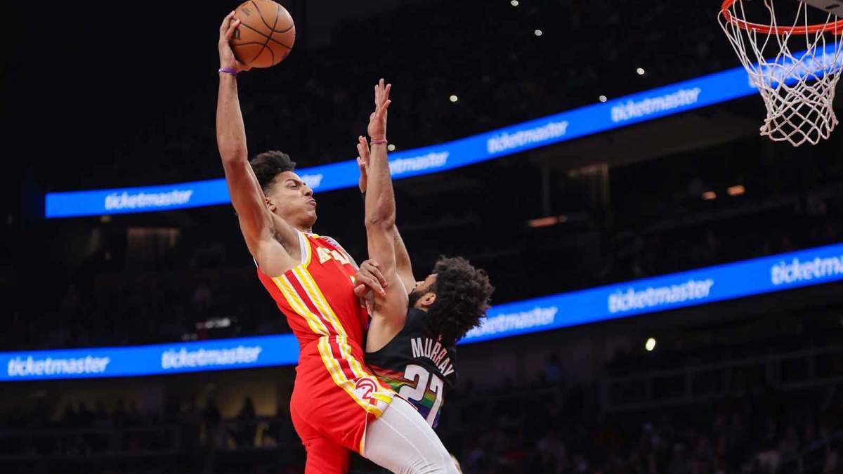 Atlanta Hawks forward Jalen Johnson (1) dunks over Denver Nuggets guard Jamal Murray (27) in the second quarter at State Farm Arena.