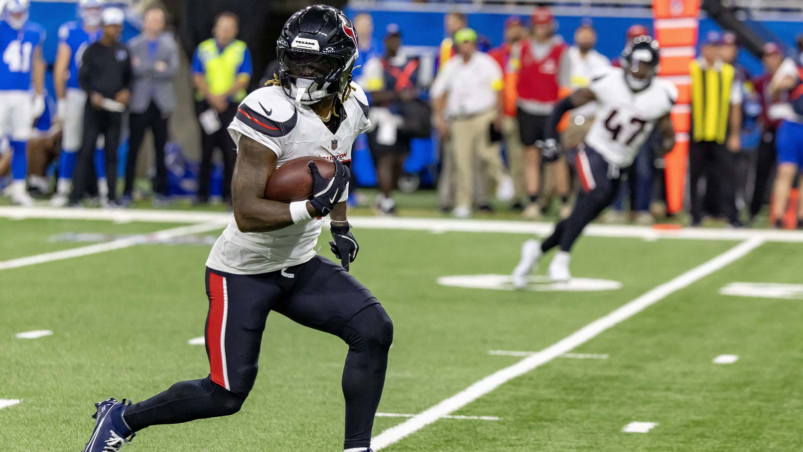 Houston Texans cornerback Jalen Mills (26) runs with the ball after his interception against the Detroit Lions during the second half at Ford Field.