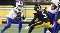 Buffalo Bills running back James Cook III (4) rushes as Pittsburgh Steelers cornerback Jalen Ramsey (5) defends during the fourth quarter at Acrisure Stadium.