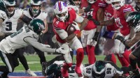 Buffalo Bills running back James Cook III finds a hole and runs through it avoiding several Eagles during first half action against the Philadelphia Eagles at Highmark Stadium in Orchard Park on Dec. 28, 2025.