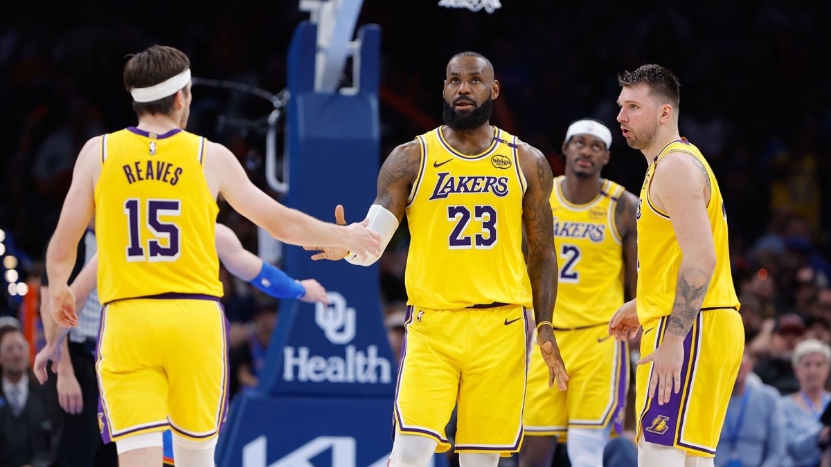 Los Angeles Lakers forward LeBron James (23) and guard Austin Reaves (15) high five after a play against the Oklahoma City Thunder during the second half at Paycom Center.