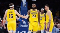 Los Angeles Lakers forward LeBron James (23) and guard Austin Reaves (15) high five after a play against the Oklahoma City Thunder during the second half at Paycom Center.