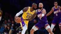 Los Angeles Lakers forward LeBron James (23) moves the ball against Phoenix Suns forward Dillon Brooks (3) during the first half at Crypto.com Arena.