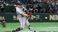 Yomiuri Giants first baseman Kazuma Okamoto (25) hits a single against the Chicago Cubs during the second inning at Tokyo Dome.