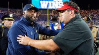 Michigan head coach Sherrone Moore, left, shakes hands with New Mexico head coach Jason Eck after 34-17 win at Michigan Stadium in Ann Arbor on Saturday, August 30, 2025.