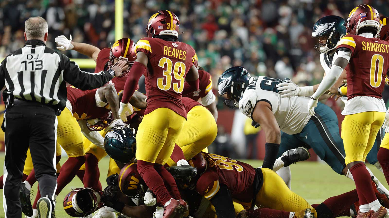 Washington Commanders and Philadelphia Eagles players fight on the field during the second half at Northwest Stadium.