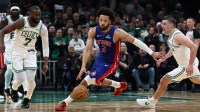 Detroit Pistons guard Cade Cunningham (2) dribbles between Boston Celtics guard Jaylen Brown (7) and guard Payton Pritchard (11) during the second half at TD Garden.