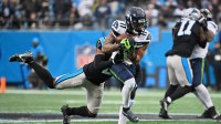 Seattle Seahawks wide receiver Jaxon Smith-Njigba (11) runs after the catch against Carolina Panthers cornerback Mike Jackson (2) (obscured) during the first quarter at Bank of America Stadium.