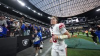 New York Giants quarterback Jaxson Dart (6) runs off the field after the game against the Las Vegas Raiders at Allegiant Stadium.