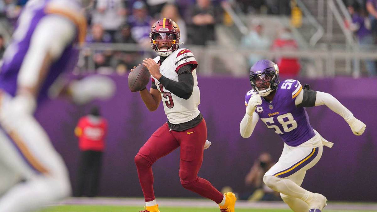 Washington Commanders quarterback Jayden Daniels (5) drops back to pass during the second half at U.S. Bank Stadium.
