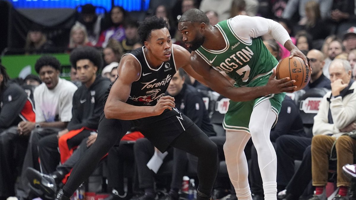 Boston Celtics forward Jaylen Brown (7) controls the ball against Toronto Raptors guard Scottie Barnes (4) during the second half at Scotiabank Arena.