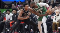 Boston Celtics forward Jaylen Brown (7) controls the ball against Toronto Raptors guard Scottie Barnes (4) during the second half at Scotiabank Arena.