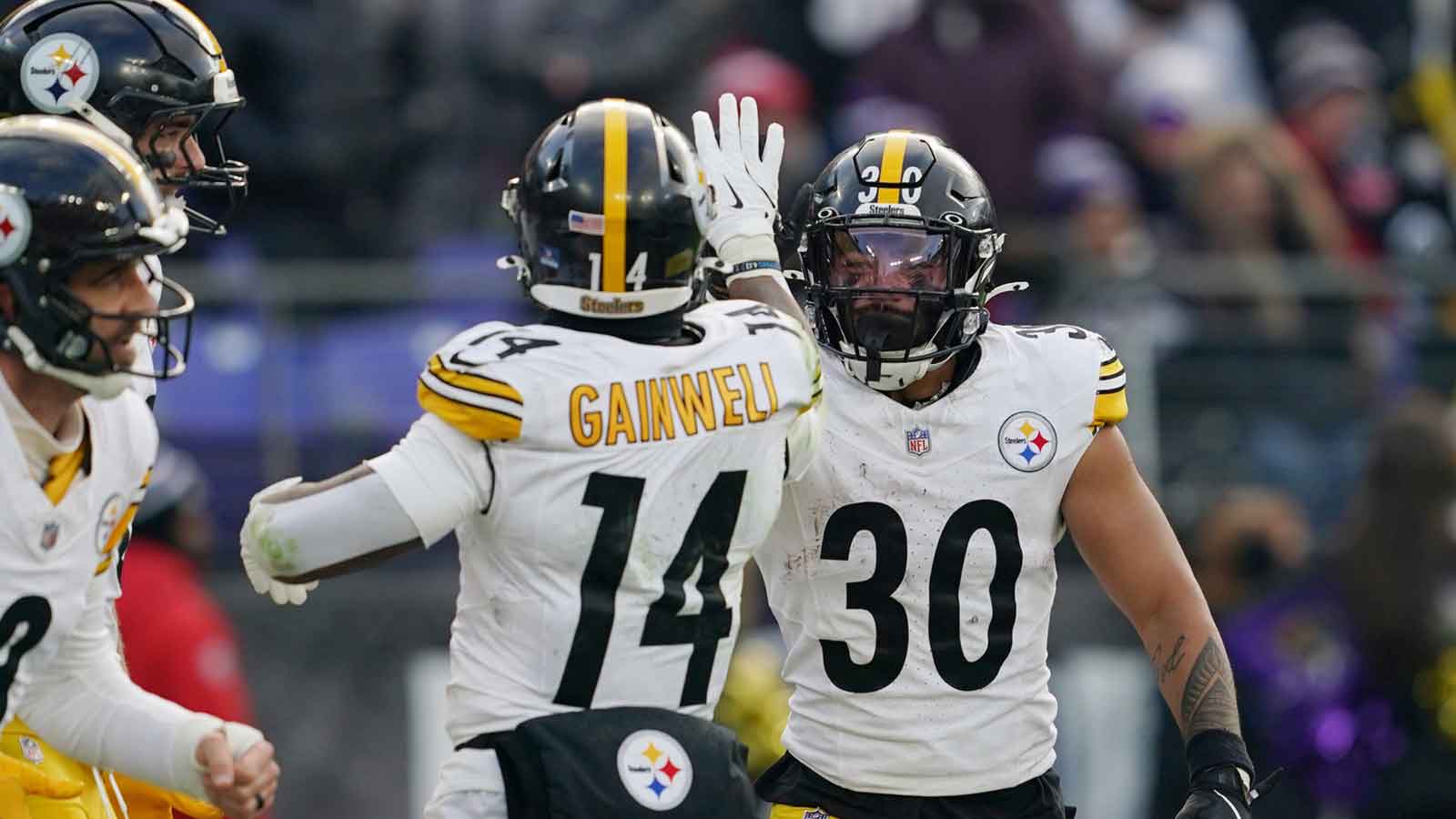 Pittsburgh Steelers running back Jaylen Warren (30) is congratulated by running back Kenneth Gainwell (14) after scoring a touchdown against the Baltimore Ravens during the second half at M&T Bank Stadium.