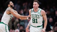 Boston Celtics forward Jayson Tatum (0) reacts after forward Blake Griffin (91) makes a three point basket against the Philadelphia 76ers in the second half at TD Garden.