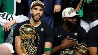 Boston Celtics forward Jayson Tatum (0) and guard Jaylen Brown (7) celebrates with the Larry O’Brian Trophy after beating the Dallas Mavericks in game five of the 2024 NBA Finals to win the NBA Championship at TD Garden.