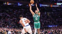 Boston Celtics forward Jayson Tatum (0) takes a three point shot past New York Knicks center Karl-Anthony Towns (32) in the fourth quarter during game three of the second round for the 2025 NBA Playoffs at Madison Square Garden.