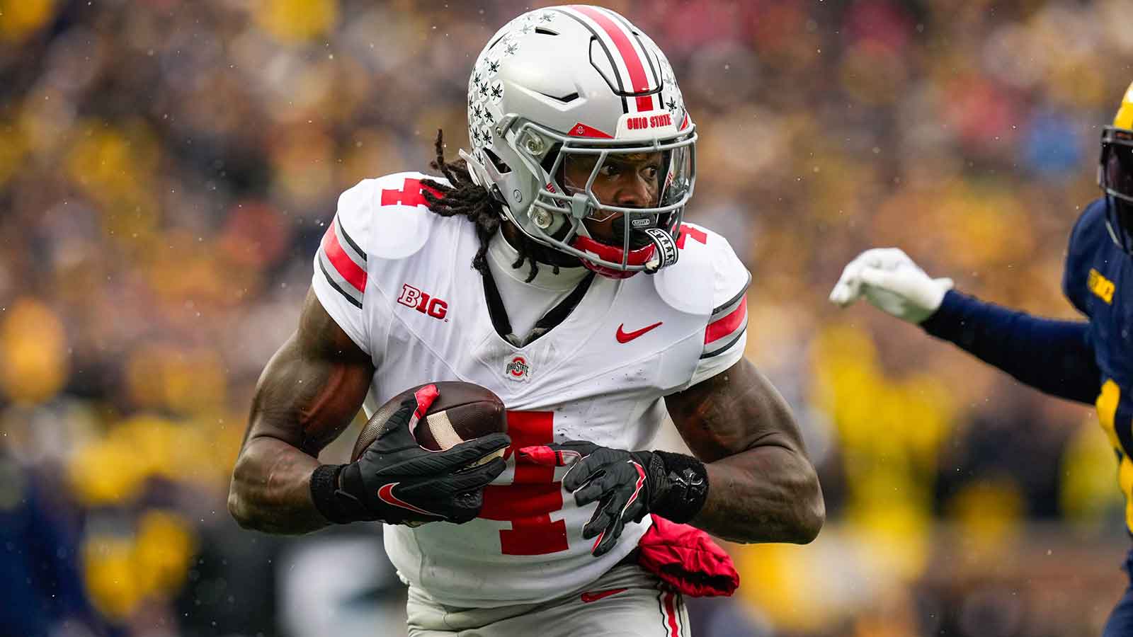 Ohio State Buckeyes wide receiver Jeremiah Smith (4) runs the ball in for a touchdown against the Michigan Wolverines in the first half of the NCAA football game at Michigan Stadium on Saturday, Nov. 29, 2025 in Ann Arbor, Michigan.