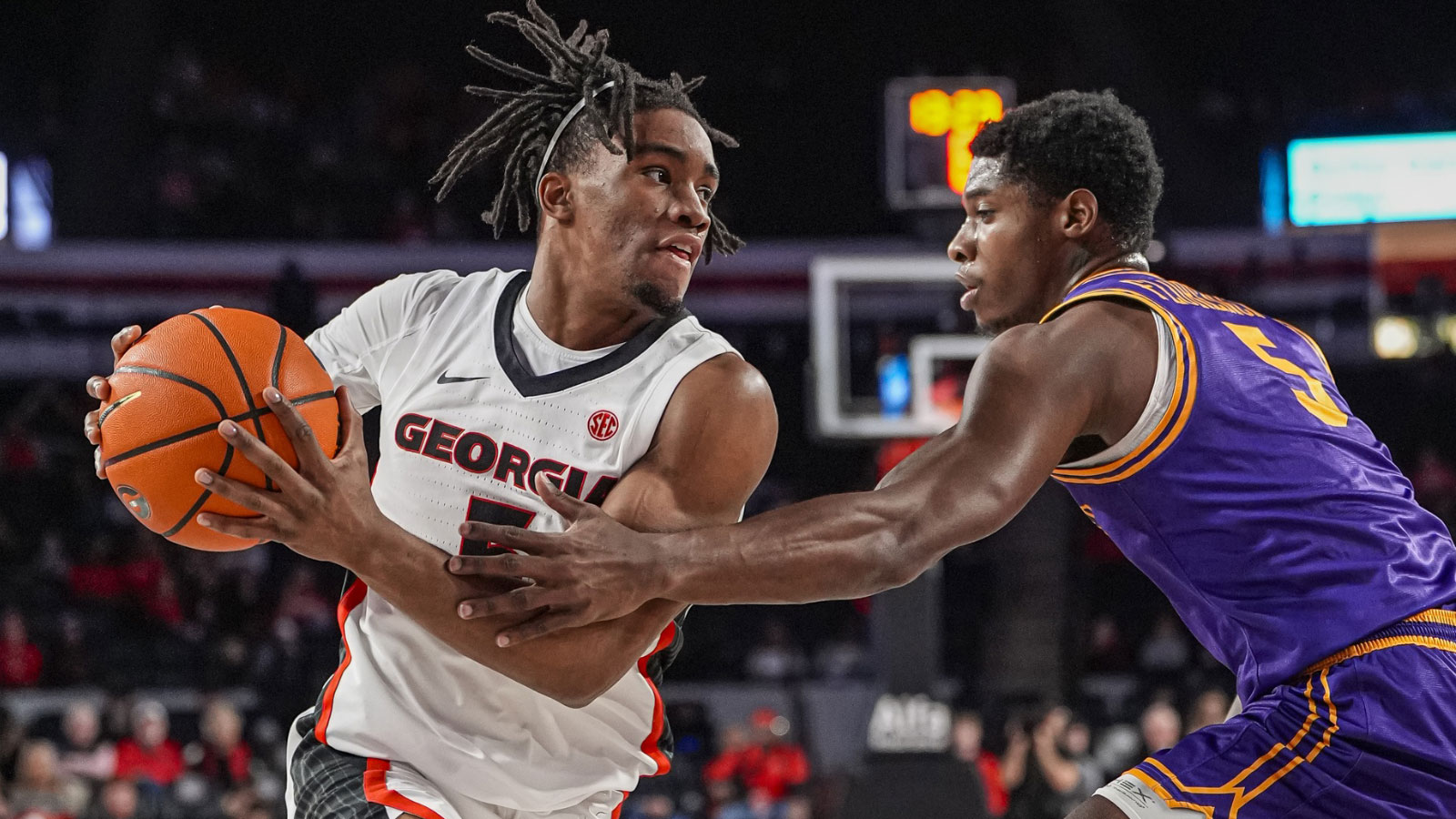 Georgia Bulldogs guard Jeremiah Wilkinson (5) protects the ball from Tennessee Tech Golden Eagles guard Ja'Quavian Florence (5) during the first half at Stegeman Coliseum.