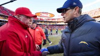 Kansas City Chiefs head coach Andy Reid, left, and Los Angeles Chargers head coach Jim Harbaugh shake hands following a Chargers victory at GEHA Field at Arrowhead Stadium.