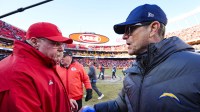 Kansas City Chiefs head coach Andy Reid, left, and Los Angeles Chargers head coach Jim Harbaugh shake hands following a Chargers victory at GEHA Field at Arrowhead Stadium.