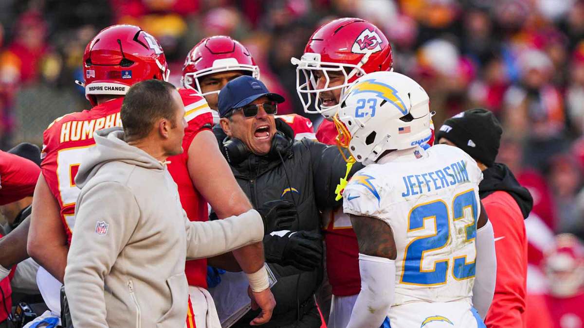Los Angeles Chargers head coach Jim Harbaugh breaks up a confrontation between safety Tony Jefferson (23) and the Kansas City Chiefs during the fourth quarter at GEHA Field at Arrowhead Stadium. Jefferson was subsequently ejected.