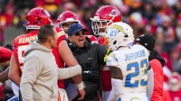 Los Angeles Chargers head coach Jim Harbaugh breaks up a confrontation between safety Tony Jefferson (23) and the Kansas City Chiefs during the fourth quarter at GEHA Field at Arrowhead Stadium. Jefferson was subsequently ejected.