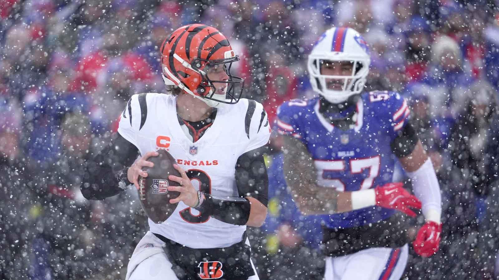 Cincinnati Bengals quarterback Joe Burrow runs away from Buffalo Bills defensive end AJ Epenesa and gets off a pass during first half action at Highmark Stadium in Orchard Park on Dec. 7, 2025.